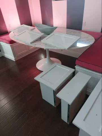 Vertical striped accent wall in pink, burgundy, and gray paint with white trim and dark hardwood flooring