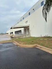 Commercial warehouse exterior with freshly painted white walls and trim
