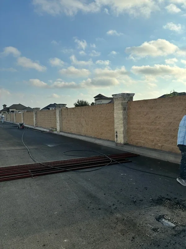 Brick and concrete perimeter wall with fresh exterior paint application